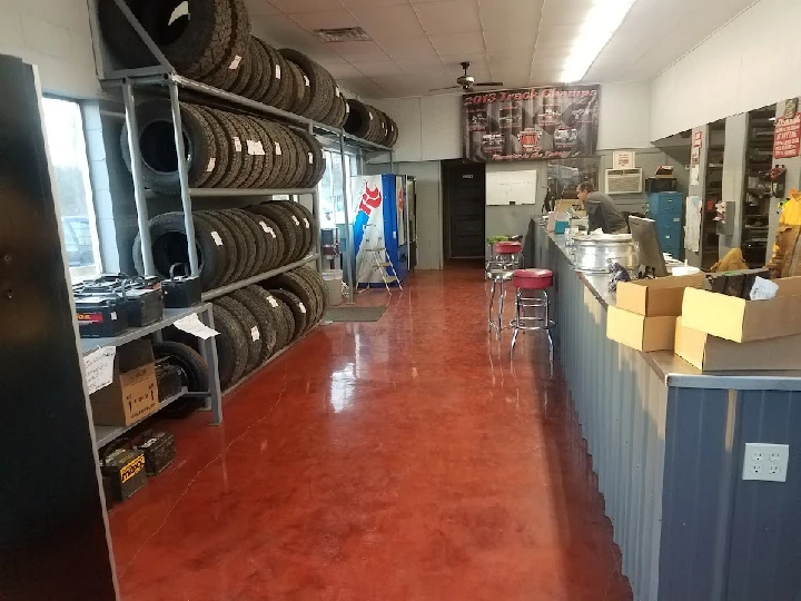 Canton Auto Salvage interior with tires and workspace.