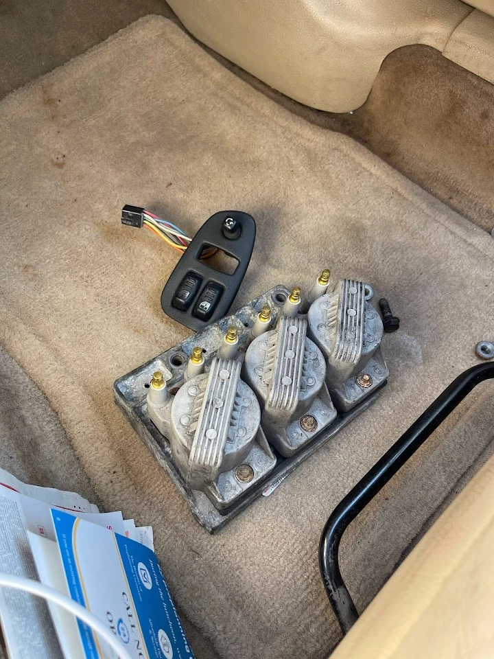 Car parts on the floor of a vehicle interior.