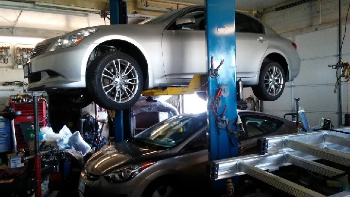 Cars being serviced in an auto repair shop.