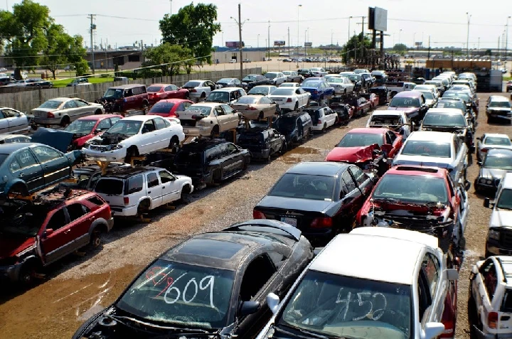 Cars stacked in a salvage yard at Best Price Auto.