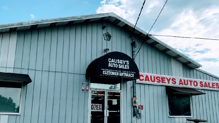 Causey's Auto Sales storefront with open sign.