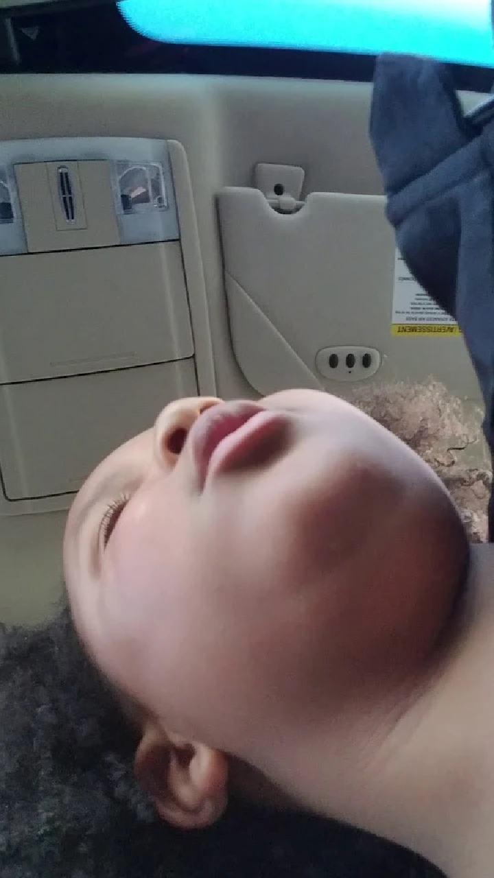 Child resting inside a vehicle.