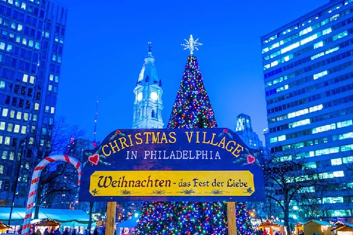 Christmas Village sign in Philadelphia at night.