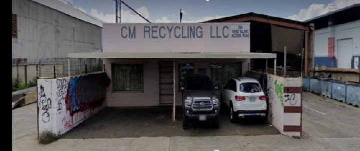 CM Recycling LLC building with parked vehicles.