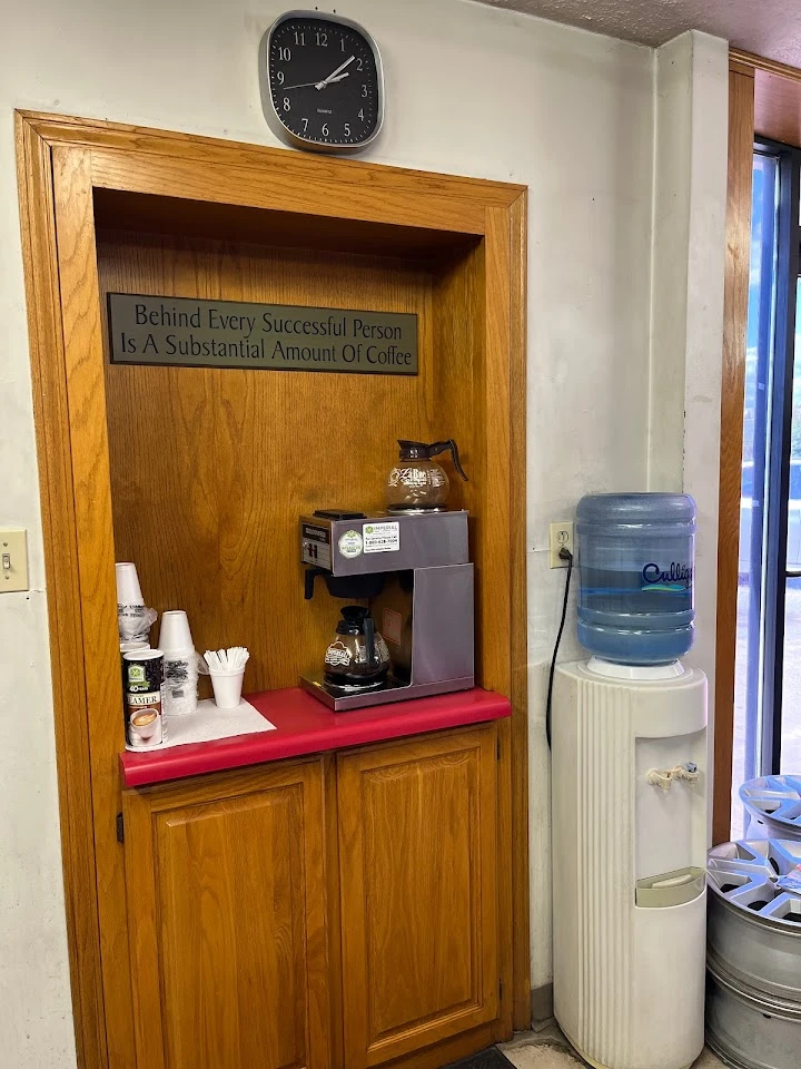 Coffee station with motivational quote and clock.