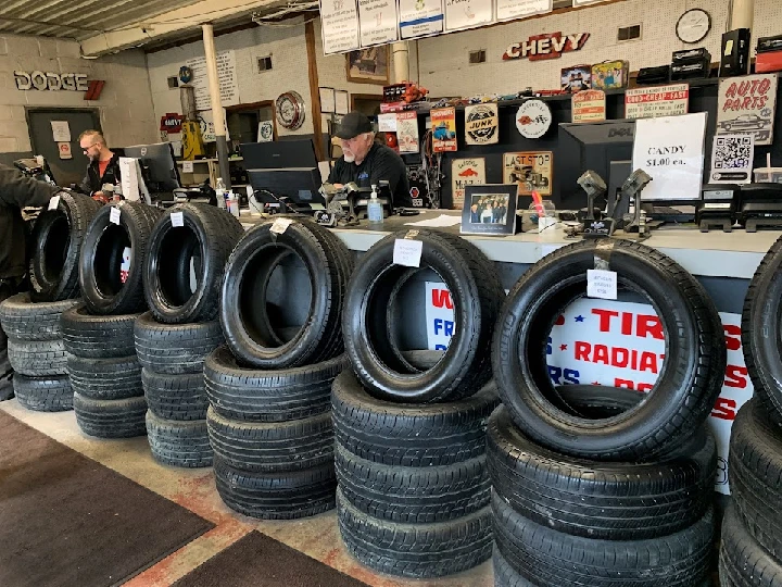 Counter at Glen's Car & Truck Parts with tires displayed.