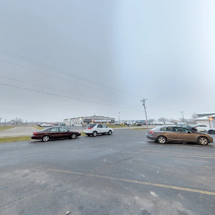 Cousineau Auto parking lot on a cloudy day.