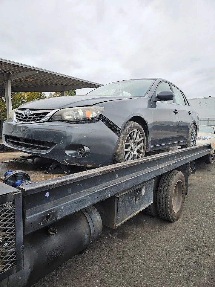 Damaged car on a tow truck ready for junking.