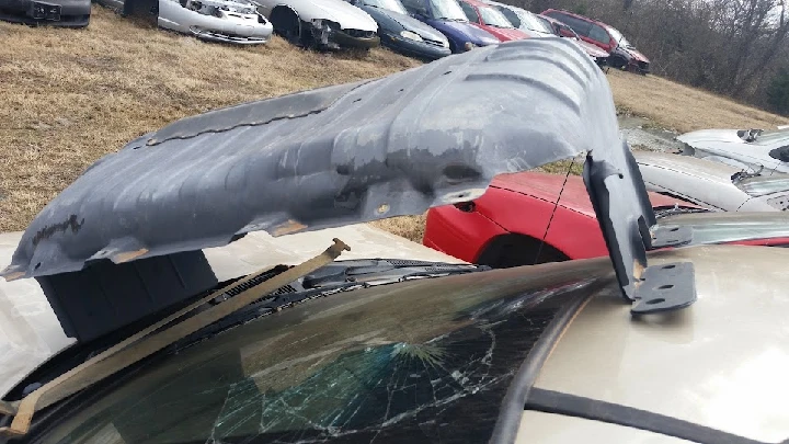 Damaged vehicle part at Branson & Sons Salvage yard.