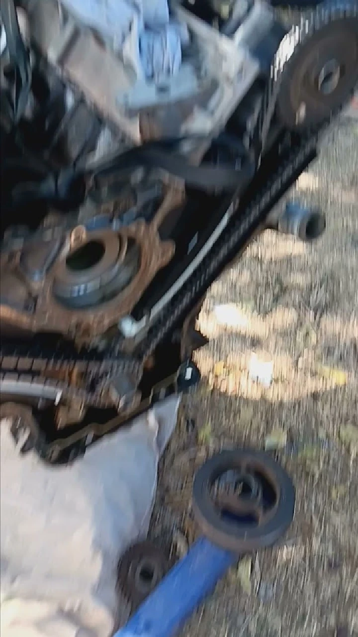 Disassembled engine parts at an auto wrecking site.