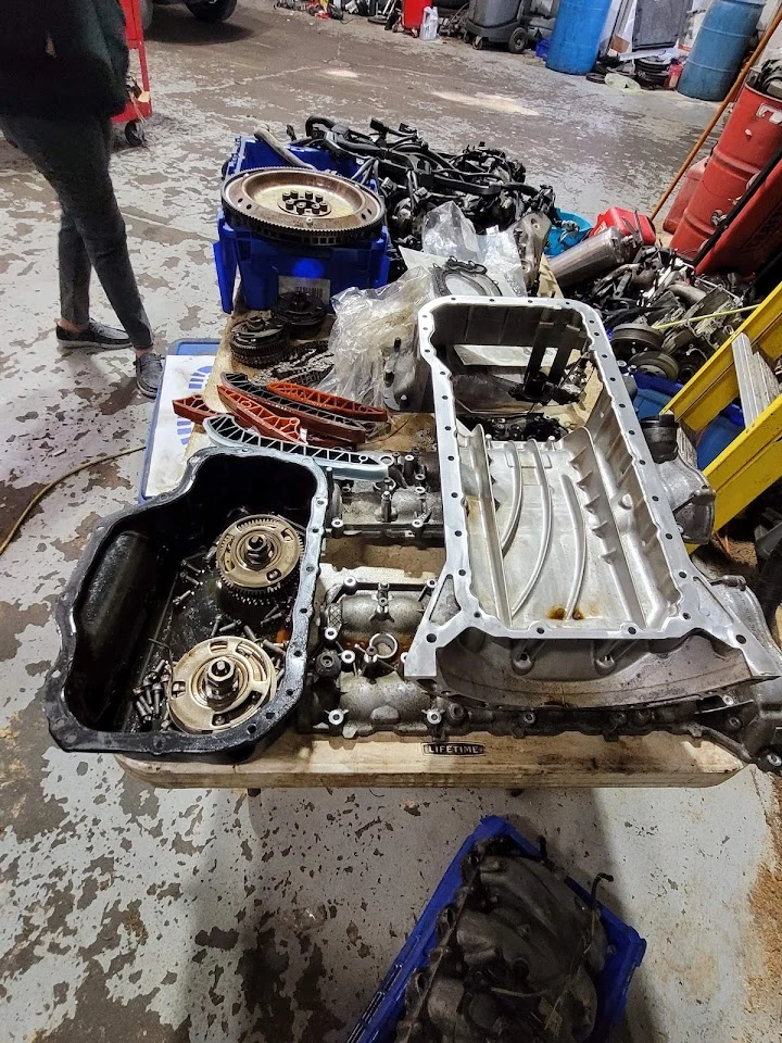 Engine parts scattered on a workbench.