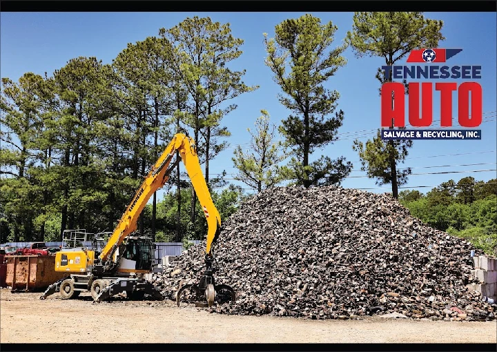 Excavator working at a junk car recycling site.