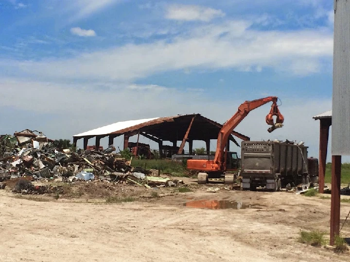 Excavator working at a metal recycling yard.