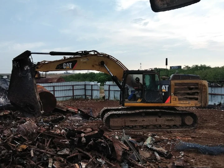 Excavator working in a scrapyard.