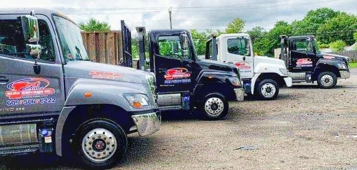 Four trucks lined up at First Class Auto Salvage.