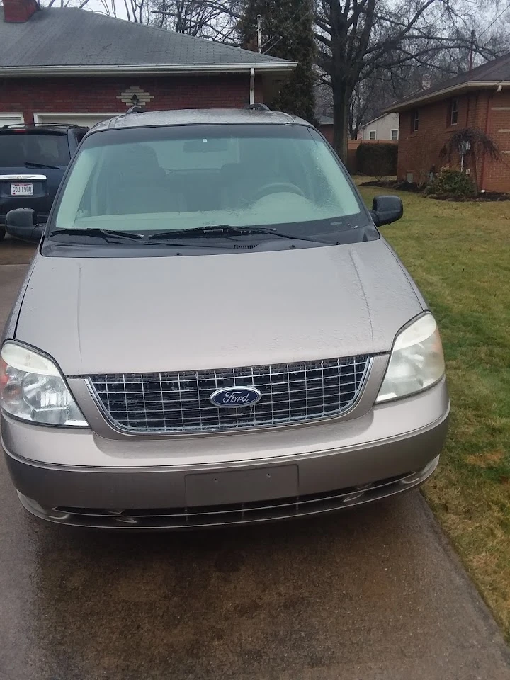 Front view of a Ford minivan, parked outdoors.