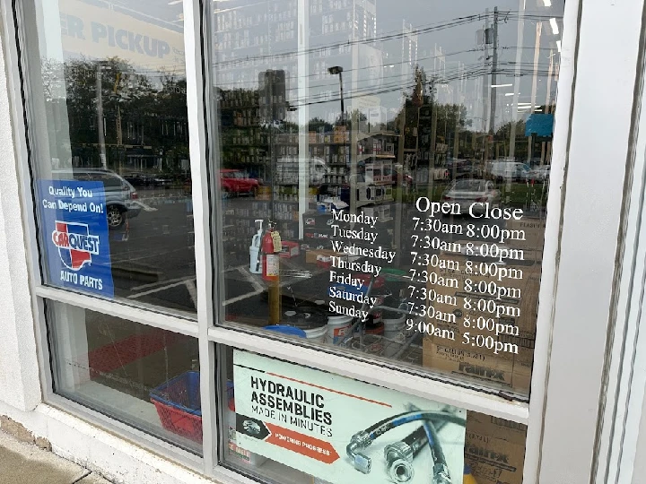 Front window of Carquest Auto Parts store hours.