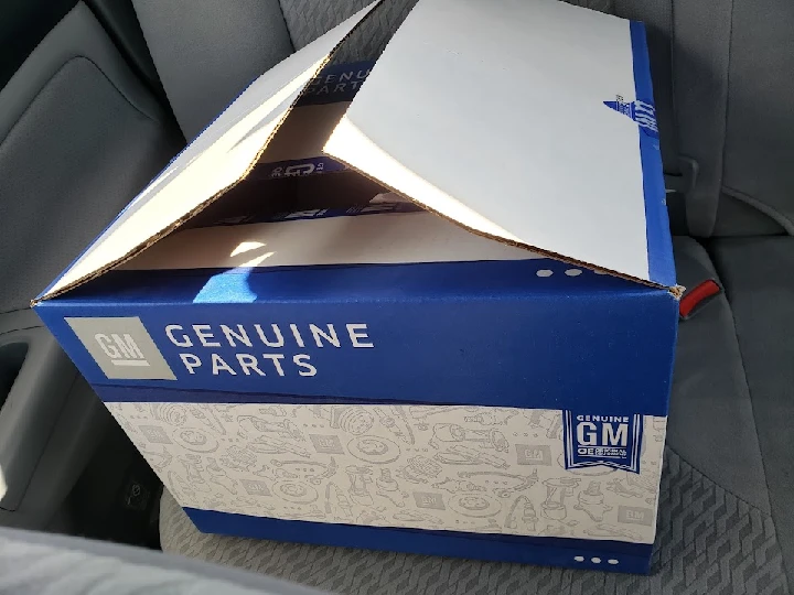 GM Genuine Parts box inside a car.