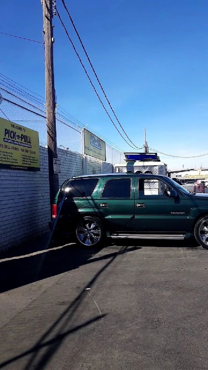 Green SUV parked at Pick-n-Pull location.