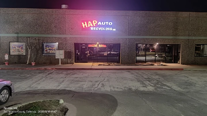 HAP Auto Recycling storefront at night.