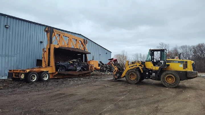 Heavy machinery at a recycling facility for junk cars.