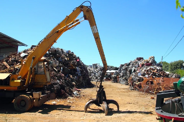 Heavy machinery at a scrap metal yard.