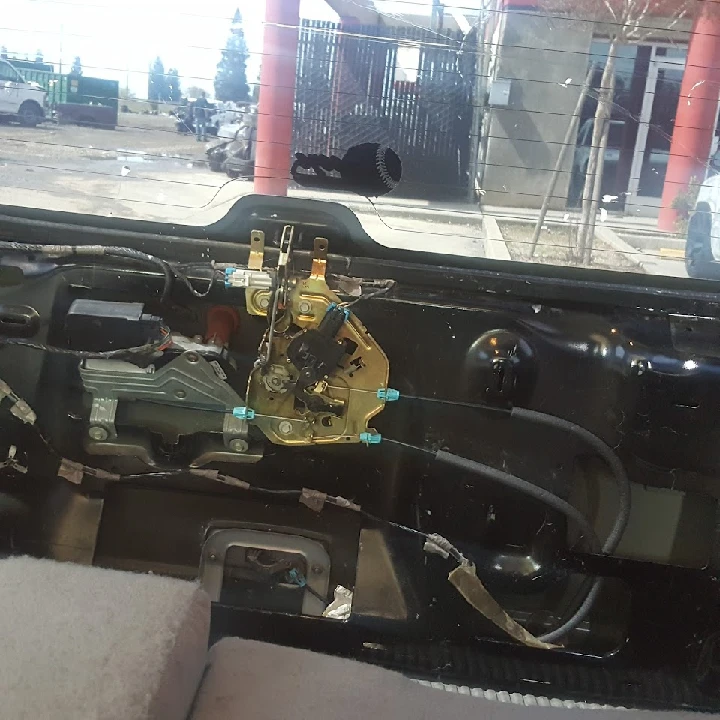 Inside view of a car's rear door mechanism.