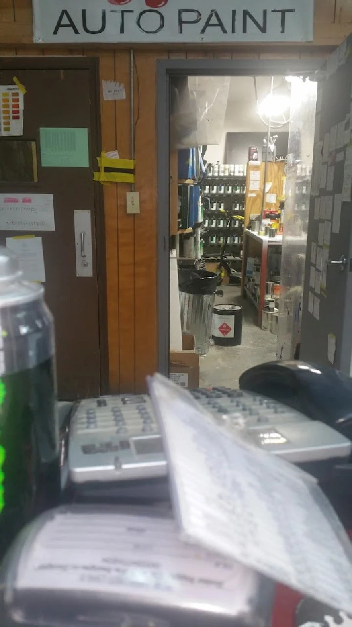 Interior of an auto paint shop, tools visible.