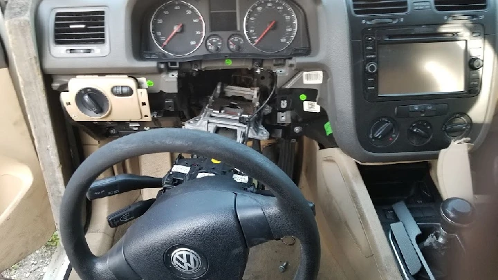 Interior of a car with disassembled dashboard components.