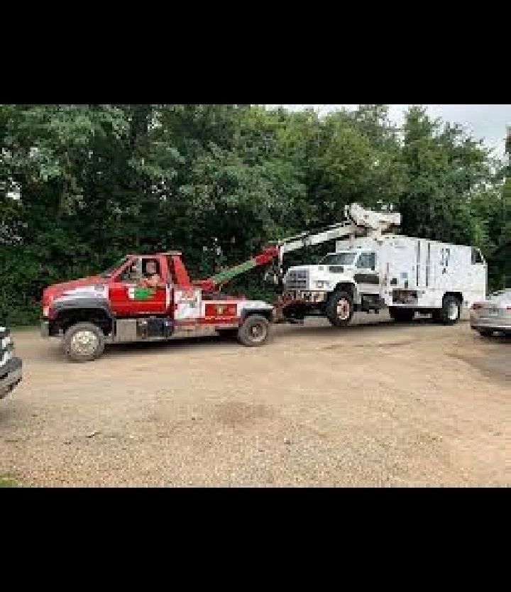 Junk car towing operation in a parking area.