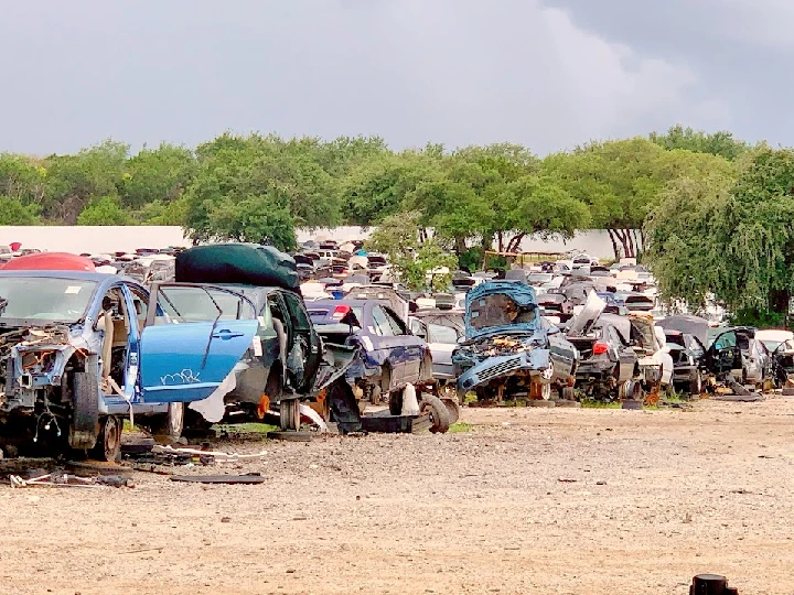 Junkyard filled with discarded cars and parts.