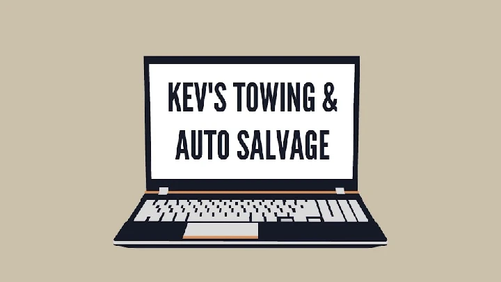 Laptop displaying Kev's Towing & Auto Salvage text.