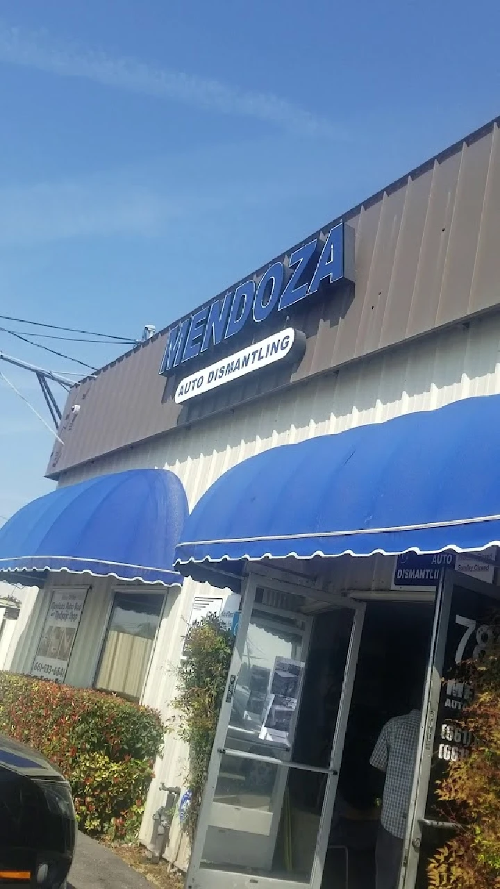 Mendoza Auto Dismantling storefront with blue awning.