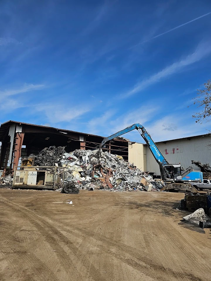 Metal recycling facility with large scrap pile.