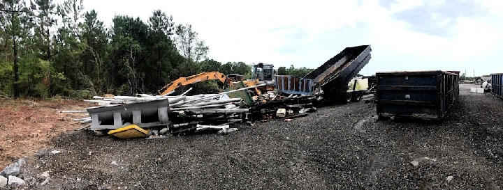 Metal recycling site with debris and equipment.