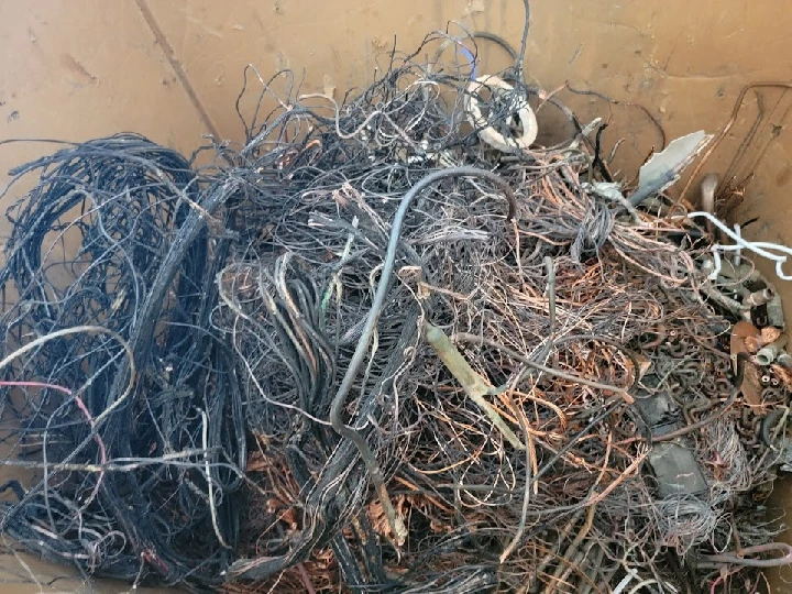 Mixed metal wires in recycling container.