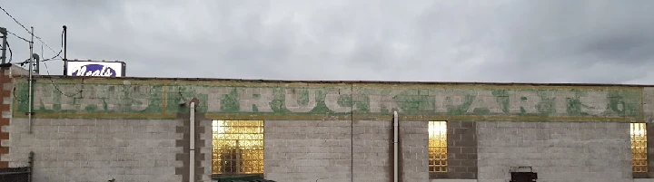 Neal's Truck Parts building exterior at dusk.