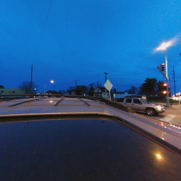 Night view from a vehicle's roof, urban scene.