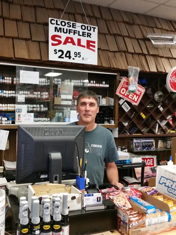 Person at counter with sale sign and auto parts displayed.