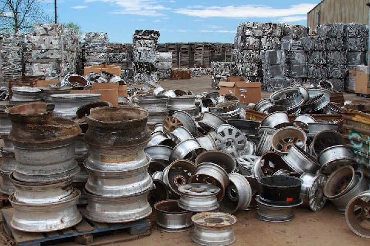 Piles of metal wheels at a recycling facility.