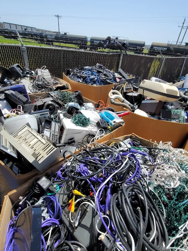 Piles of tangled electronic waste for recycling.