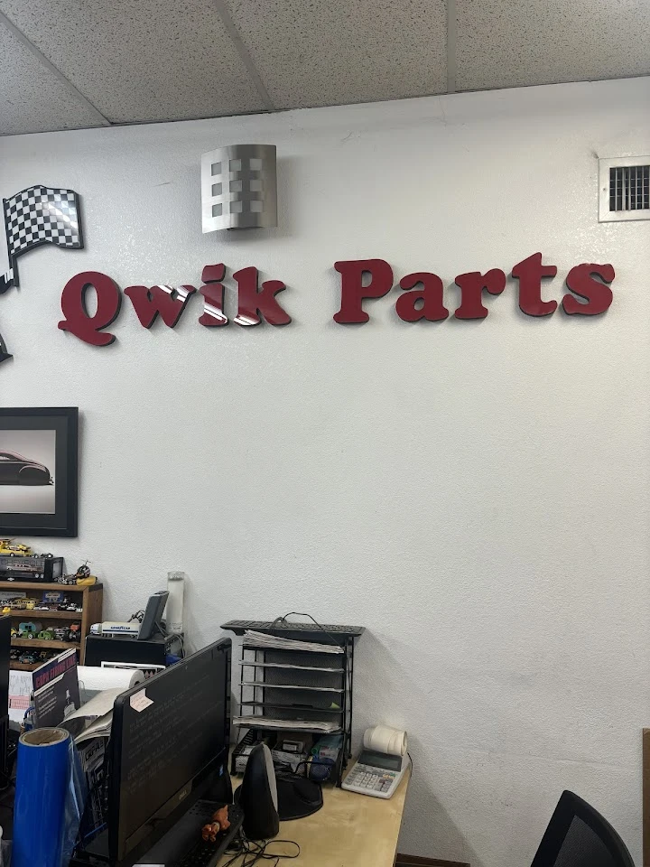 Qwik Parts sign on the wall of an office.