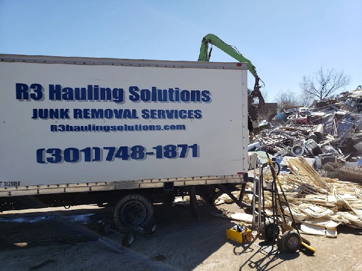 R3 Hauling Solutions junk removal truck at recycling site.