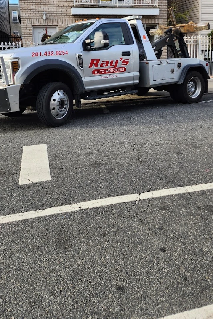 Ray's Auto Wreckers tow truck parked on the street.