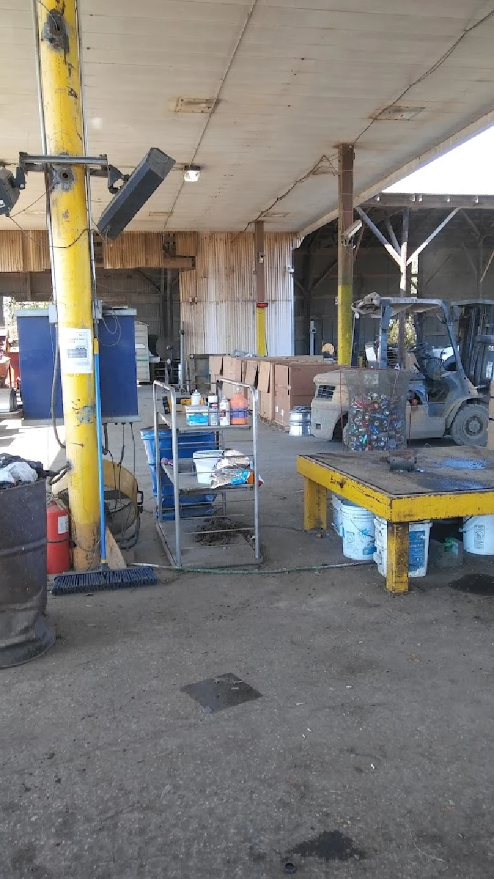 Recycling facility interior with equipment and supplies.