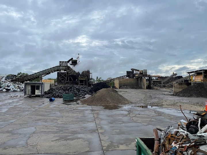 Recycling facility with machinery and scrap materials.