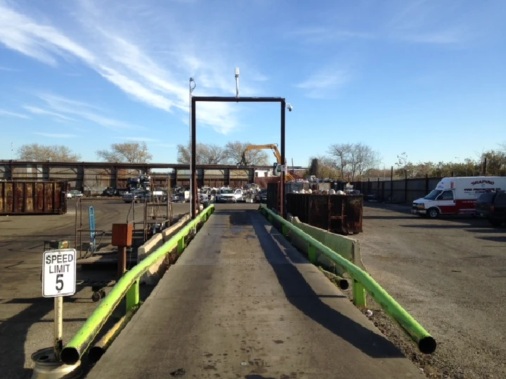 Recycling facility with weigh station and vehicles.