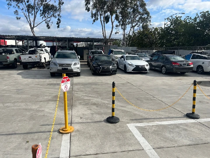 Recycling yard with various parked vehicles.