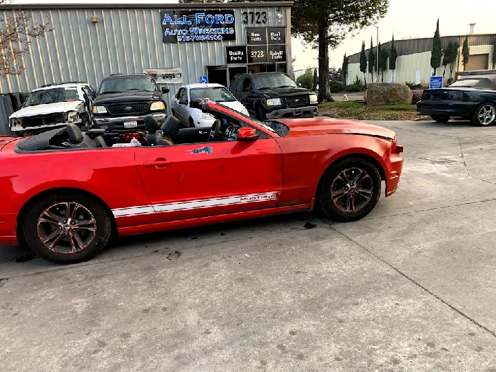 Red Mustang convertible at All Ford Auto Wrecking.