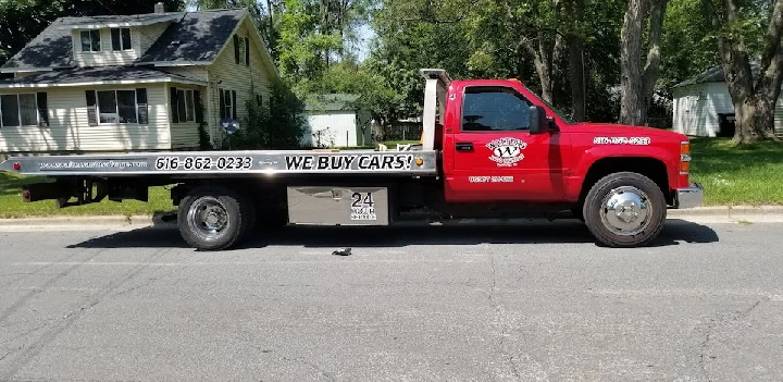 Red tow truck from Walters Auto Salvage parked.